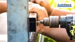fence contractor repairing a metal fence