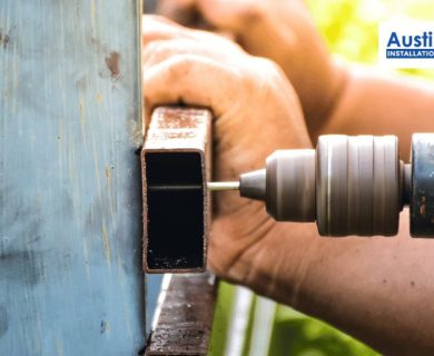 fence contractor repairing a metal fence