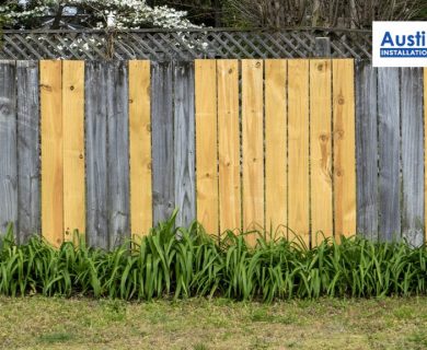 wooden fence with some new replaced panels